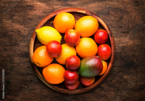 Bright fruits in large tray  oranges  lemons  mango in assortment. View from above