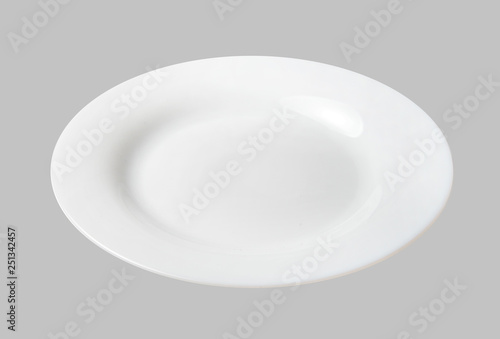 White dessert plate. Light gray isolated background. Top side view. Close-up.