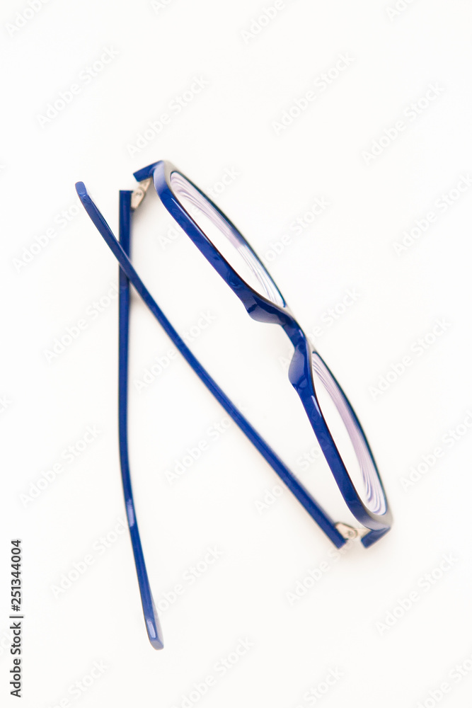 Glasses in the blue frame on a white ground, flat lay Glasses in the blue frame on a white ground, flat lay