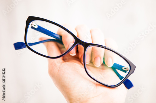 Glasses in the blue frame in hand