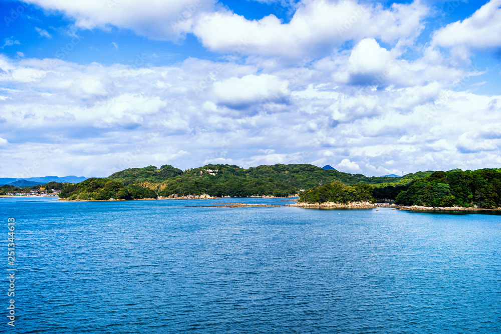 Many small islands over the blue ocean in sunny day, famous Kujukushima(99 islands) pearl sea resort islet in Sasebo Saikai National Park, Nagasaki, Kyushu, Japan. Many small islands over the blue ocean in sunny day, famous Kujukushima(99 islands) pearl sea resort islet in Sasebo Saikai National Park, Nagasaki, Kyushu, Japan.