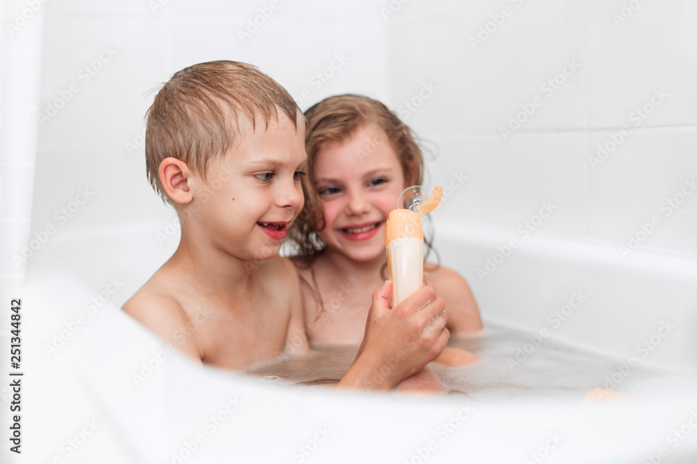 Sister Washes His Inferior Brother happy children boy and girl 6-7 years old, brother and sister have fun