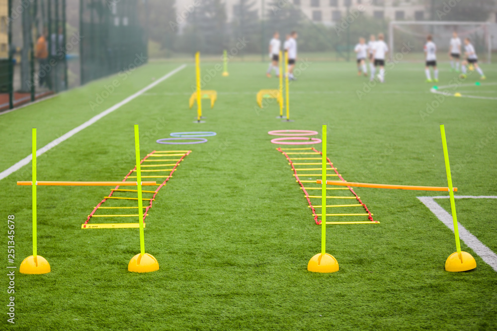 Soccer field with training equipment and fence in background. Junior  football team training with coach in the background. Soccer football  training session for kids foto de Stock | Adobe Stock