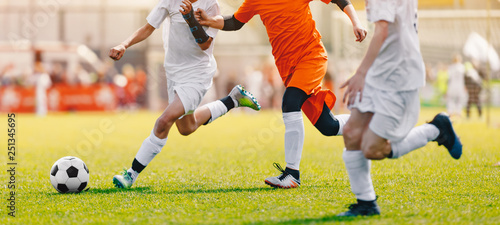 Soccer Shot. Young Boys Kicking Football Soccer Tournament Match on the Grass Pitch. Football Players Duel. Running Soccer Players from Youth School Soccer Teams © matimix