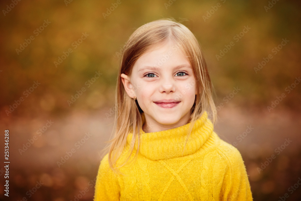 portrait of a little girl in a yellow sweater in autumn portrait of a little girl in a yellow sweater in autumn