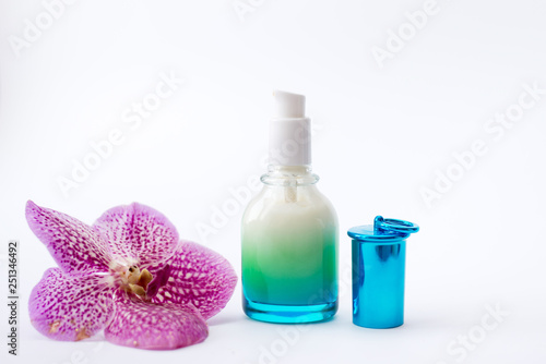 Jar of cream and pink flower on white background, top view. Professional cosmetic products