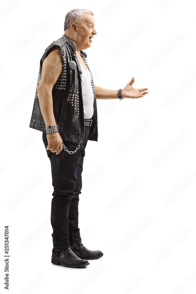 Mature male punker in a leather vest gesturing with hand Mature male punker in a leather vest gesturing with hand