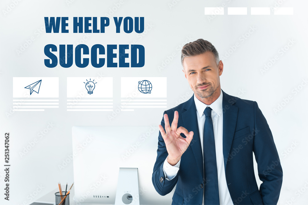 handsome businessman showing okay gesture and looking at camera isolated on white with handsome businessman showing okay gesture and looking at camera isolated on white with