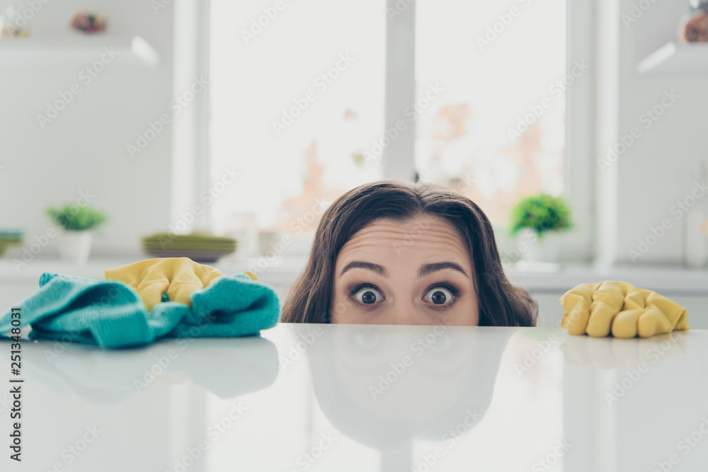 Portrait of her she nice cute lovely beautiful girlish funny shocked wavy-haired house-wife hiding behind shine glossy table in modern light white interior indoors - obrazy, fototapety, plakaty 