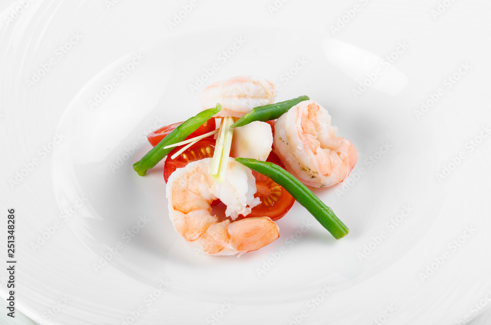 Serving Tom Yam Soup: Chef lays cherry tomatoes, king prawns, green beans and greens before serving soup Serving Tom Yam Soup: Chef lays cherry tomatoes, king prawns, green beans and greens before serving soup