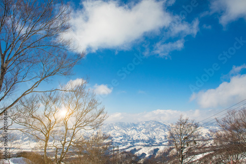 Landscape and Mountain view of Nozawa Onsen in winter with sunshine, Nagano, Japan.