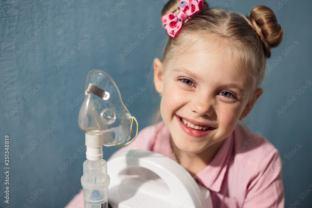 a little pretty blonde girl 5 - 6 years old in pink, breathes a ...