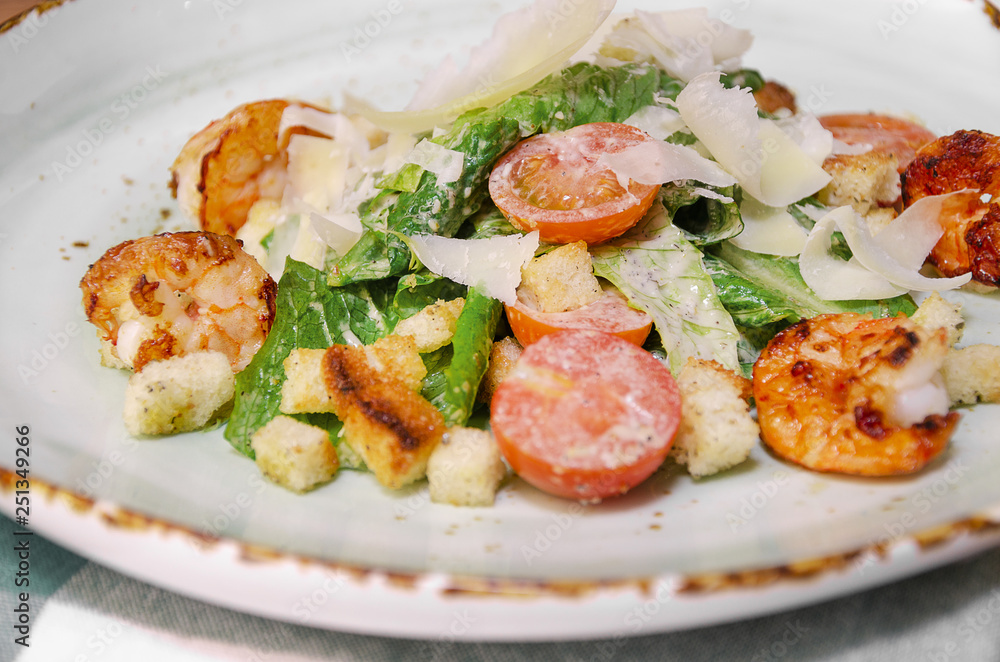 Shrimp Caesar salad with Parmesan cheese, croutons and lettuce