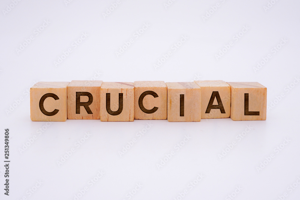 Crucial Word Written In Wooden Cube Crucial Word Written In Wooden Cube