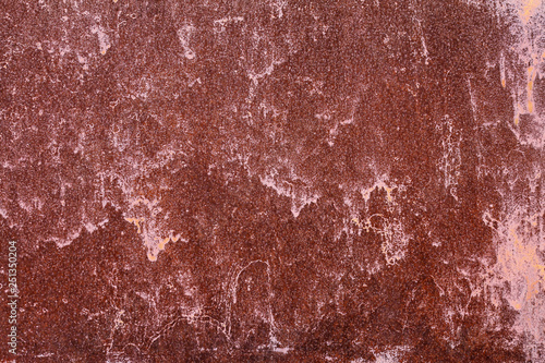 Old painted metal surface. Rusty metal, peeling paint, red tones. Worn metallic iron panel.