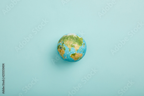 Fototapeta Naklejka Na Ścianę i Meble -  top view of planet model on turquoise background, earth day concept