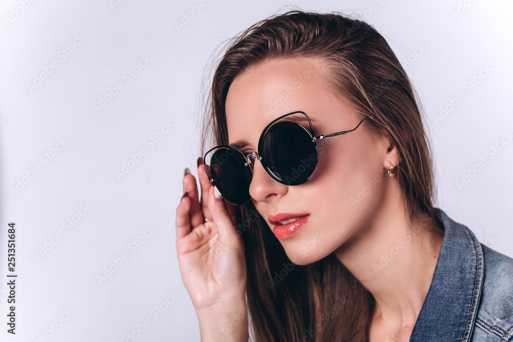 Close up portrait of young gorgeous beauty student girl in black hat on grey background looking at camera Close up portrait of young gorgeous beauty student girl in black hat on grey background looking at camera