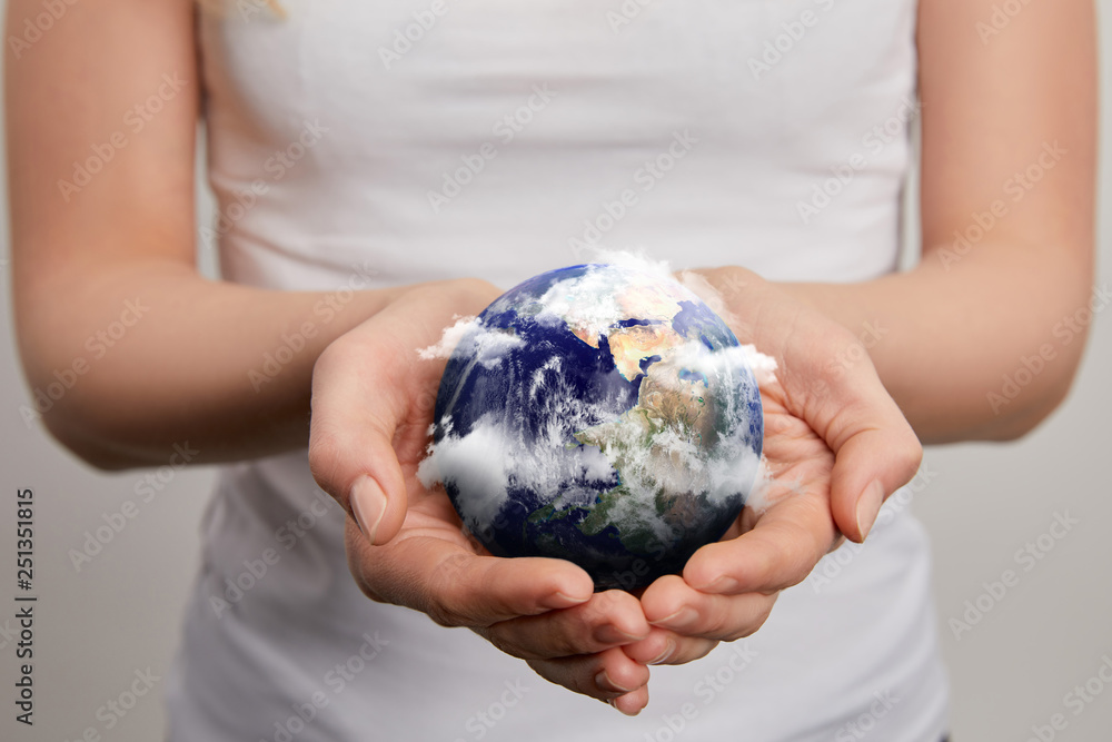 woman holding planet model on grey background, earth day concept woman holding planet model on grey background, earth day concept