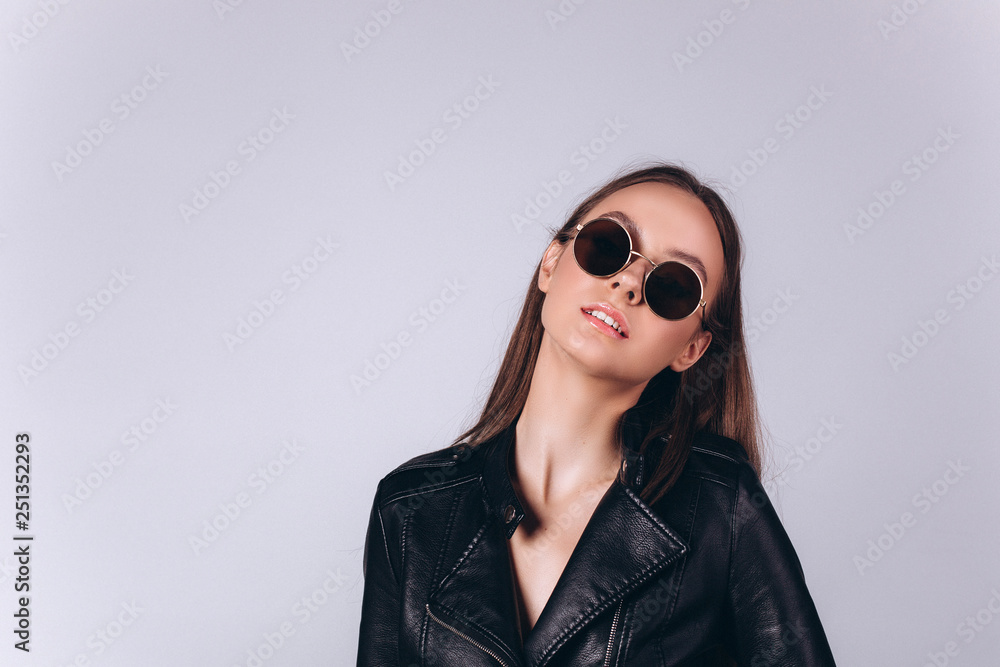 Beautiful smart serious fashionable professional model posing in studio. Business, fashion, beauty concept Beautiful smart serious fashionable professional model posing in studio. Business, fashion, beauty concept