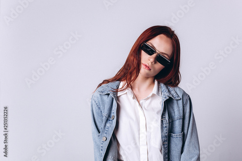 Portrait of young smart beautiful fashionable caucasian student girl with red headed hairstyle on white background. Business, knowledge, education concept