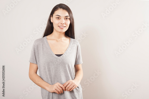 Young beautiful portrait woman on gray background