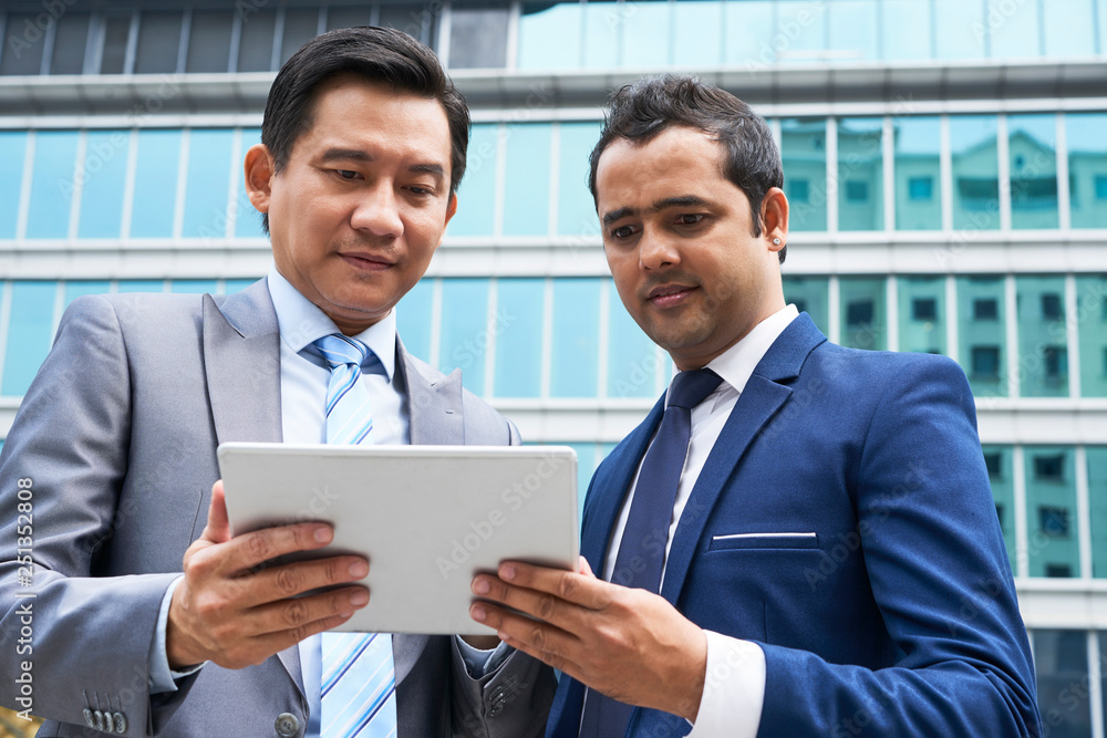 Business partners using tablet pc Business partners using tablet pc