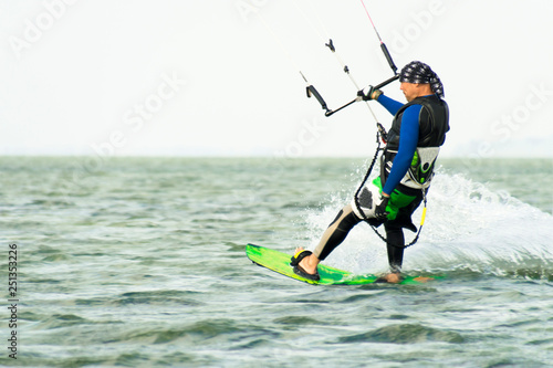 Kitesurfing Kiteboarding action photos man among waves quickly goes