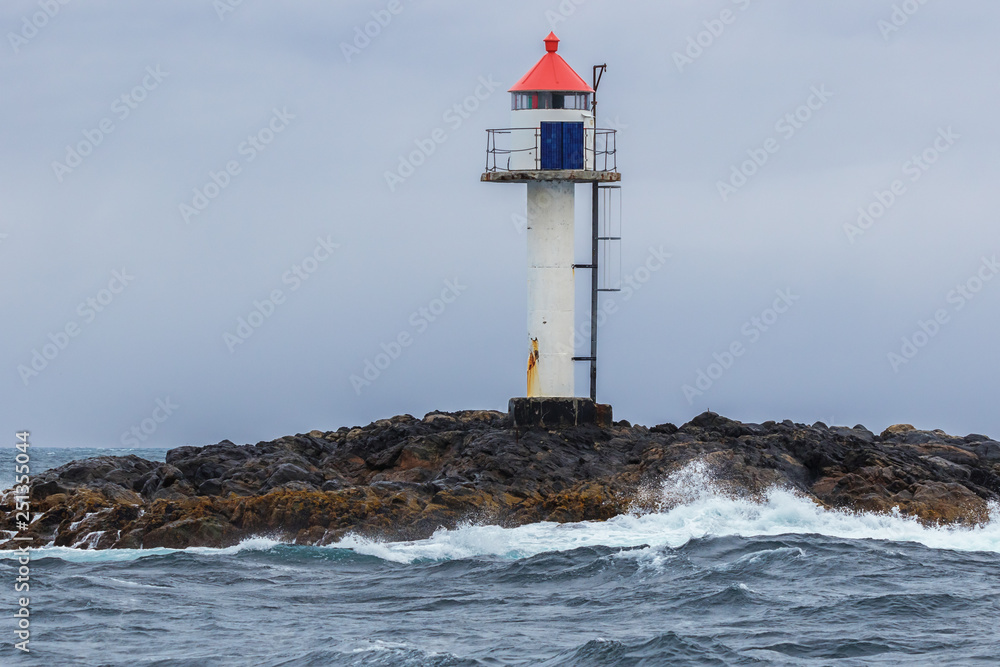 The lighthouse of Bleik at the entrance of the harbor when coming from Bleiksoya