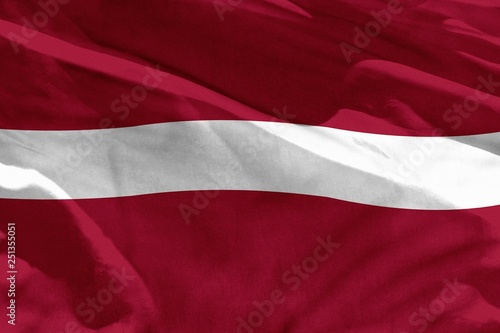 Waving Latvia flag for using as texture or background, the flag is fluttering on the wind