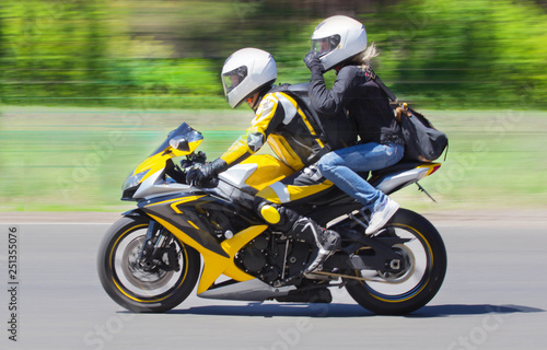 Active couple riding on the motorbike  slow motion  having fun in bikers tour  happy adventure concept on spring road