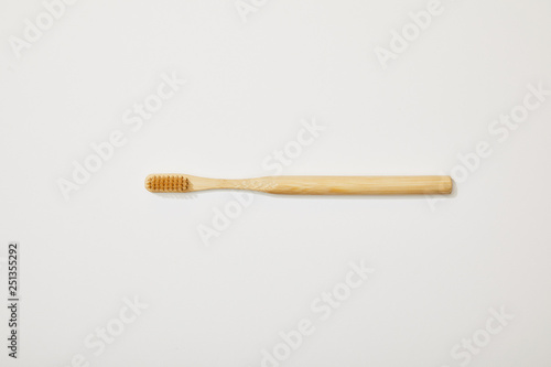 top view of bamboo toothbrush on white background