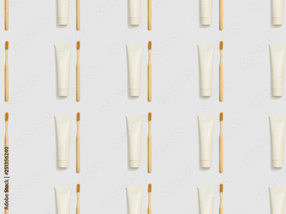 bamboo toothbrushes and toothpaste in tubes on grey background, seamless background pattern bamboo toothbrushes and toothpaste in tubes on grey background, seamless background pattern