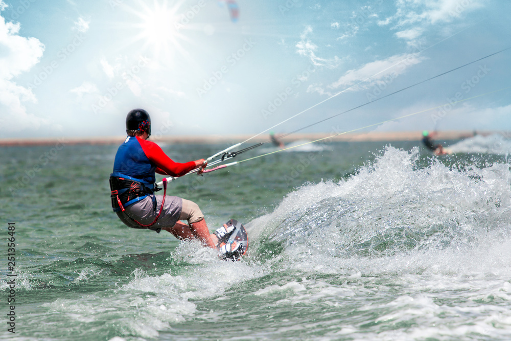 Obraz premium Kite surfing in waves. Splash water. Extreme summer sport at sunny day