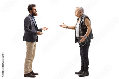 Bearded man having a conversation with an angry male punker in a leather vest