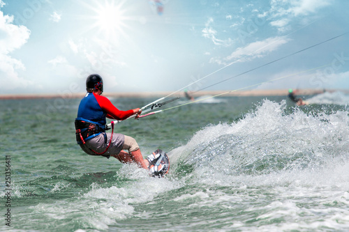 Kite surfing in waves. Splash water. Extreme summer sport at sunny day