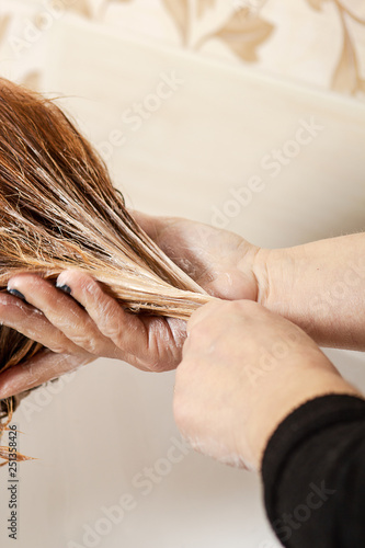 Hairdresser apply hairmask photo