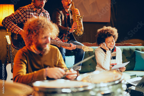 Multicultural jazz band practicing for the gig in home studio.