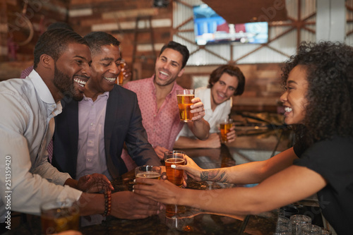 Photography Barmaid Serving Group Of Male Friends On Night Out For Bachelor Party Making Toa