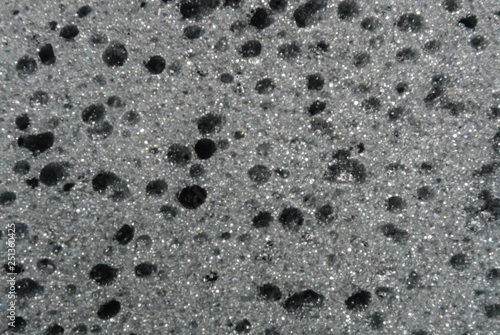 Beautiful black foam rubber texture with a hole