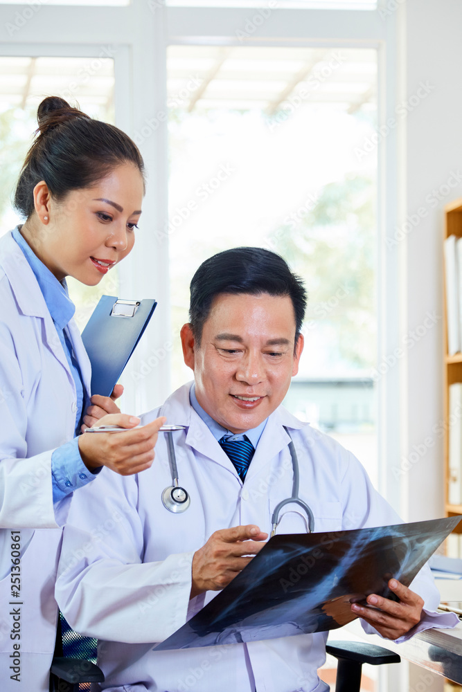Doctors looking at x-ray scan Doctors looking at x-ray scan