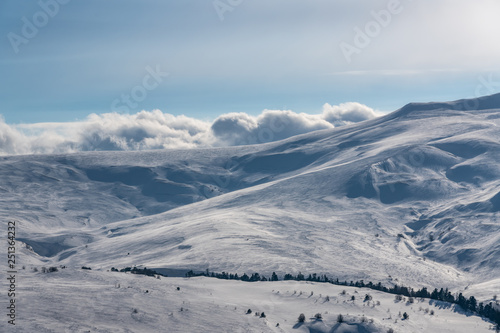 Wonderful winter mountain landscape: Clouds lie on mountain snow-capped peaks Lago-Naki, The Main Caucasian Ridge, Russia © SergioDenisenko