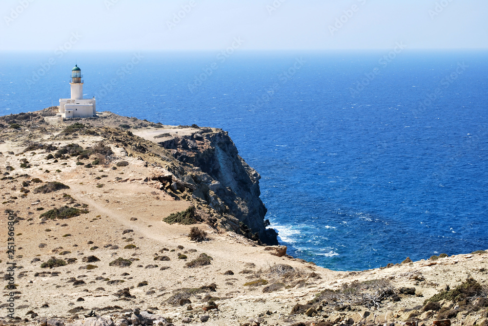 View of the lighthouse on a stone cliff above the sea against the sky, Prasonisi, Rhodes island, Greece View of the lighthouse on a stone cliff above the sea against the sky, Prasonisi, Rhodes island, Greece
