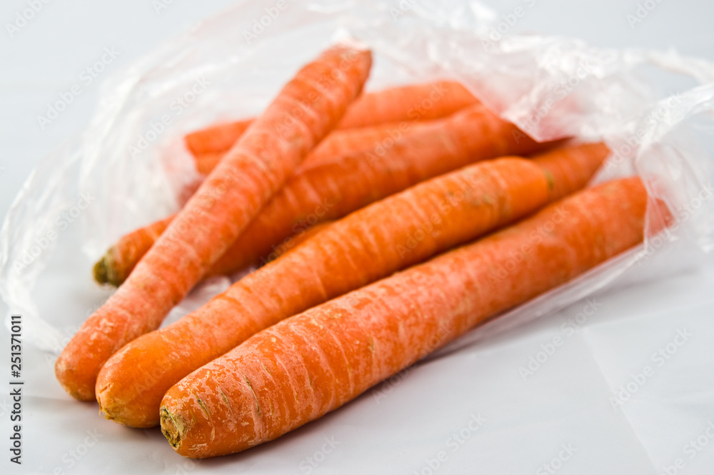 Carrots in plastic bag isolated on white Carrots in plastic bag isolated on white