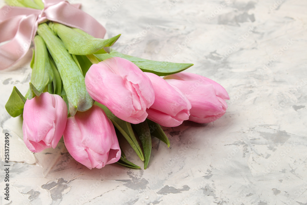 A bouquet of beautiful pink tulips flowers on a light concrete background. Spring. holidays. free space A bouquet of beautiful pink tulips flowers on a light concrete background. Spring. holidays. free space