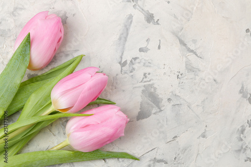 A bouquet of beautiful pink tulips flowers on a light concrete background. Spring. holidays. top view. free space