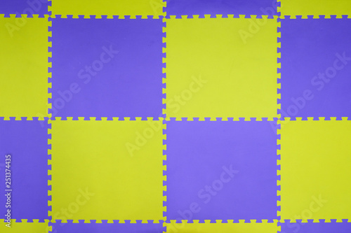 dirty playground mat for children in public place, blue and yellow color rubber jigsaw.