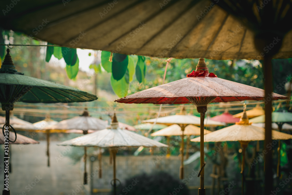 Outdoor decoration with old fashioned umbrella, old native colorful umbrella in garden background and nature