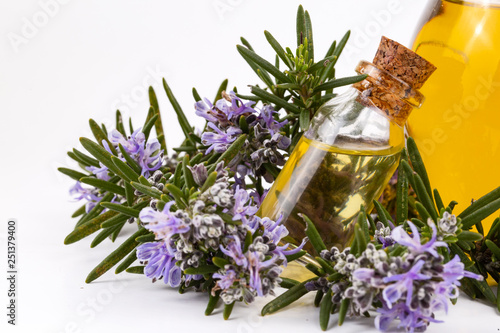 Rosemary essential oil in a small bottle. Natural aroma cosmetic oil