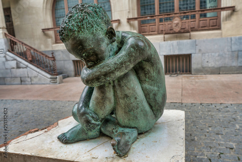 Sad Child bronze sculpture in the middle of Vitoria-Gasteiz, Spain. photo