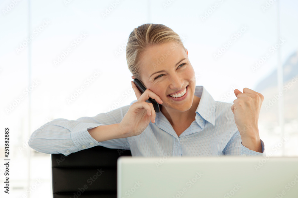 woman on the phone at workplace - successful businesswoman using smartphone in office woman on the phone at workplace - successful businesswoman using smartphone in office